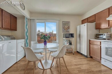 Kitchen equipped with washing machine and clothes 