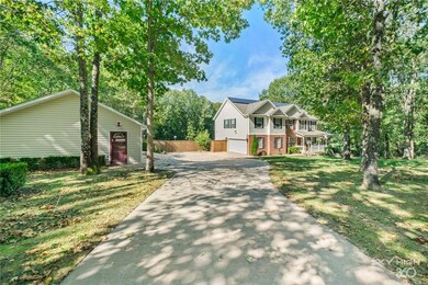 Additional 3 car garage on the left with 1200 sq ft Quonset Hut behind the garage.