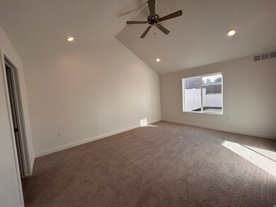 Empty room featuring lofted ceiling, recessed lighting, carpet floors, and a ceiling fan