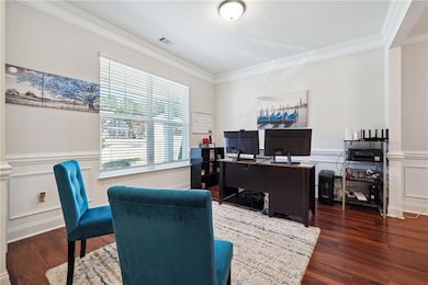 Home office featuring dark hardwood / wood-style f