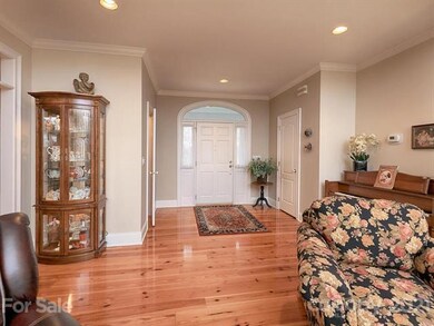 Foyer features gleaming hard pine flooring.