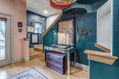 Foyer entrance with plenty of natural light, wood finished floors, and recessed lighting