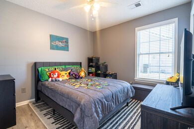 Bedroom featuring wood finished floors, visible ve