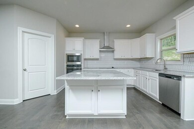 Kitchen featuring stainless steel appliances, wall