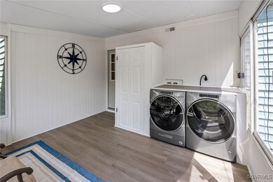 Washroom with visible vents, wood finished floors,