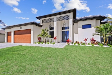 View of front of home featuring a front yard, a ga