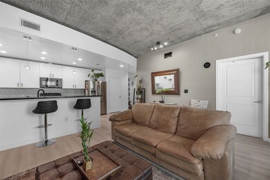 The living room features soft, neutral-toned walls