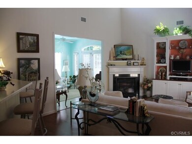 Family Room with custom shelving, gas FP, and hard