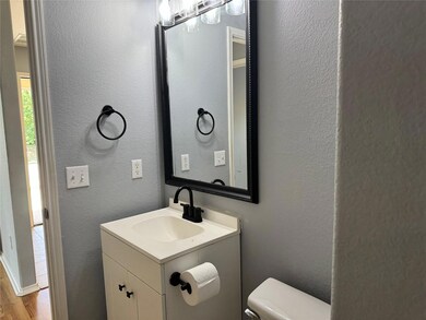 Bathroom featuring hardwood / wood-style floors, vanity, and toilet