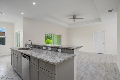 Kitchen featuring dishwasher, gray cabinetry, ceil