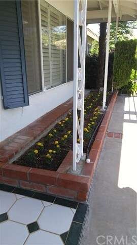 Freshly planted flowers welcome you home.