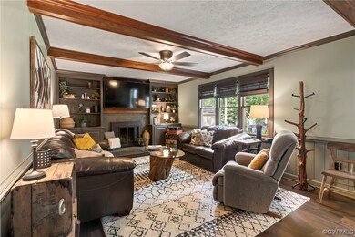 Living room with a fireplace, a textured ceiling,