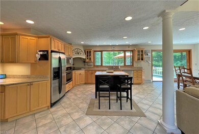 Open concept Kitchen with maple cabinets, island w