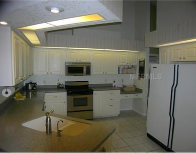 Kitchen - Great kitchen offers Corian countertops, plenty of storage, over-sized refrigerator and freezer, built-in desk and a view to the waterfront.