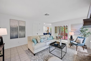 Living room featuring baseboards, visible vents, 