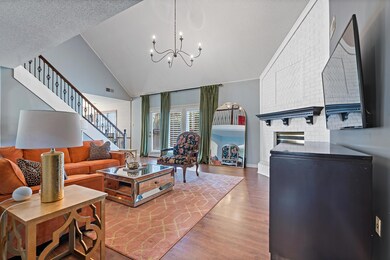 Living room featuring high vaulted ceiling, an inv