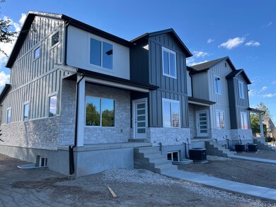 Modern farmhouse featuring stone siding and board and batten siding