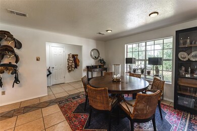 Tiled dining space featuring a textured ceiling