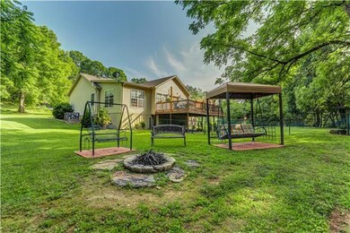 View of the swings and the fire pit that will rema