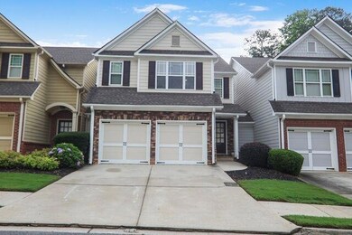 View of property with driveway, an attached garage, and roof with shingles