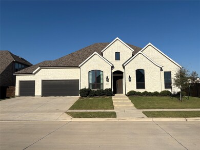 French provincial home with a front lawn, driveway, an attached garage, brick siding, and roof with shingles