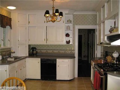 Kitchen. Kitchen updates include tile flooring, solid surface countertops, commercial type gas range.
