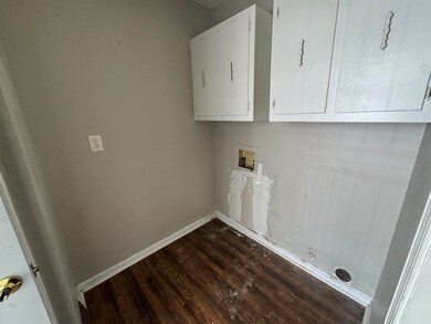 Laundry room with washer hookup, dark wood finishe