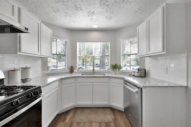 The single, oversized stainless steel sink overlooks the front of the home with a view. Ceramic subway tile backsplash was also added.