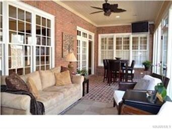 Tall windows in the sunroom allow natural light to