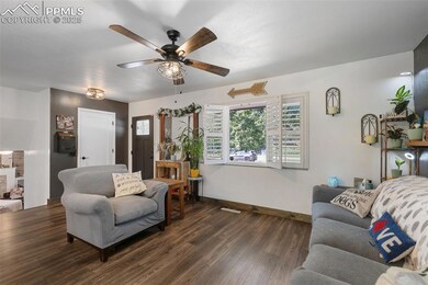 Living area with wood finished floors and a ceiling fan