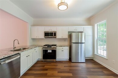 Kitchen featuring backsplash, appliances with stai