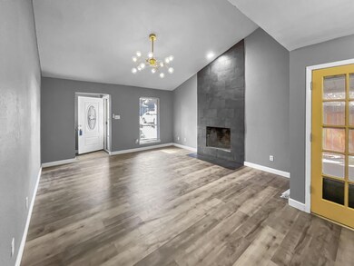 Unfurnished living room featuring a tiled fireplac