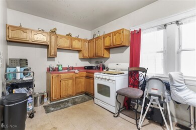 Kitchen featuring gas range gas stove, brown cabinetry, and light flooring