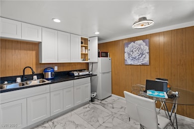 Kitchen featuring freestanding refrigerator, open