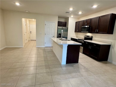 Kitchen featuring a sink, stainless steel appliances, visible vents, and light tile patterned floors