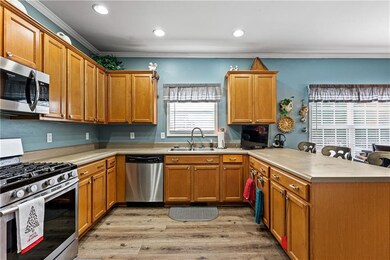 Kitchen featuring ornamental molding, a sink, stai