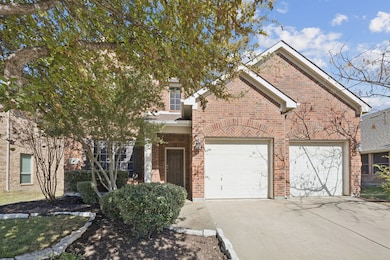 View of front facade with concrete driveway, brick siding, and an attached garage