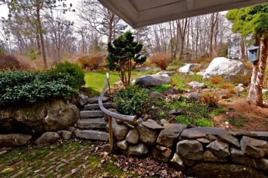 Rustic handrail and stone steps to...