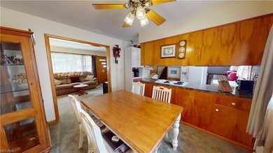 Carpeted dining room featuring ceiling fan