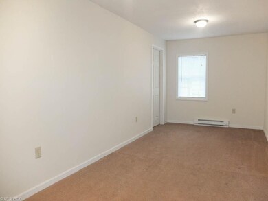 Spacious living room with new carpet.