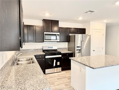 Kitchen featuring stainless steel appliances, ligh