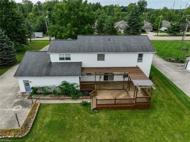 Back of property with a yard and a deck