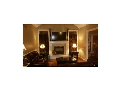 Night view of great room with gas fireplace and fl