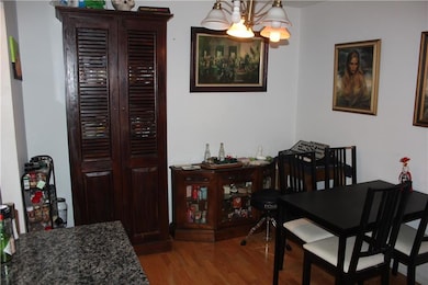 Dining room featuring wood finished floors and a chandelier