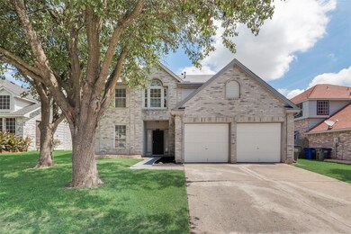 View of property featuring a garage and a front ya