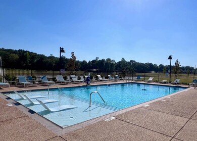 Pool with a patio area and fence