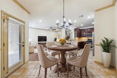Dining space with a chandelier, crown molding, li