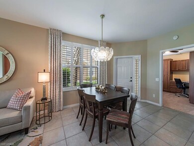 Bright,  neutral and inviting dining area with natural light pouring in from double windows having Plantation Shutters, new lighting fixture, window treatments, and a table that opens to 90