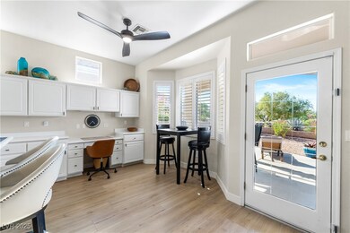 Office area with ceiling fan, baseboards, and buil