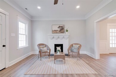 Living room with new floors and wood burning fire